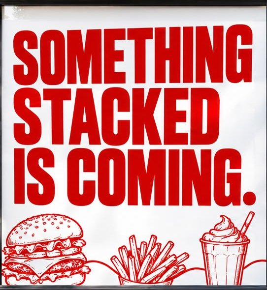 Something Stacked Is Coming window sign
